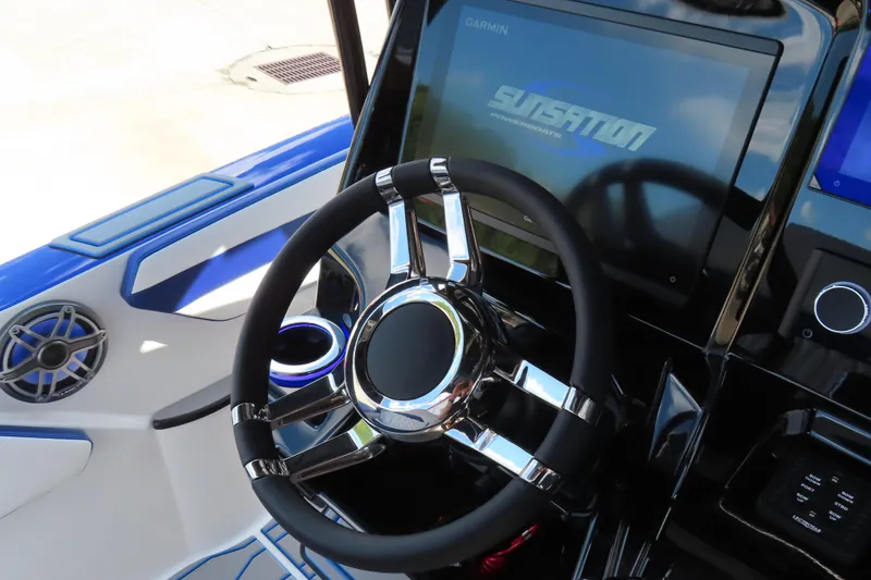 Slide: The Image of 2026 Sunsation 32CCX boat dashboard with sleek steering wheel and modern controls. - 14