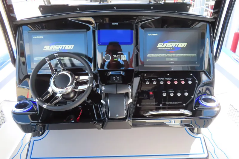 Slide: The Image of 2026 Sunsation 32CCX boat dashboard with dual Garmin displays and modern controls. - 15