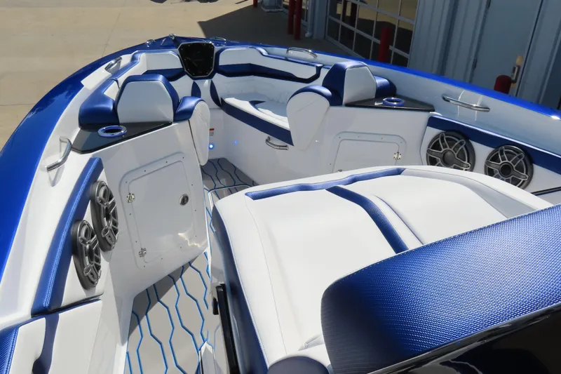 Slide: The Image of 2026 Sunsation 32CCX boat interior with blue and white seating, speakers, and modern design. - 16