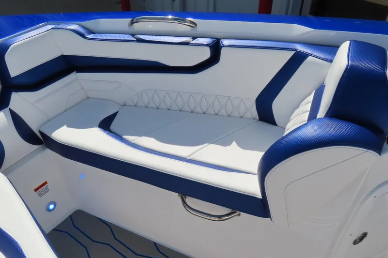Slide: The Image of Luxurious seating in the 2026 Sunsation 32CCX boat, featuring blue and white upholstery. - 18
