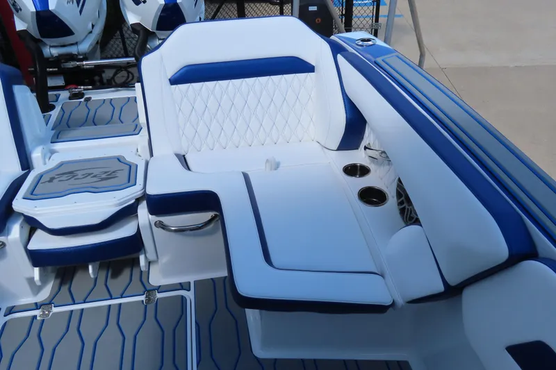 Slide: The Image of 2026 Sunsation 32CCX boat interior with blue and white seating and cup holders. - 22