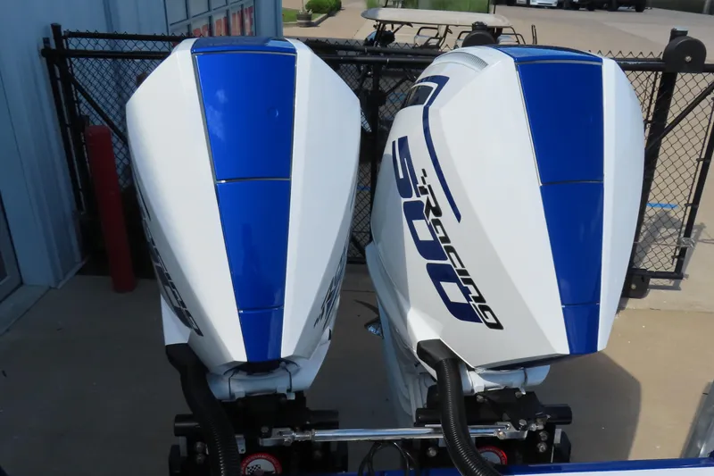 Slide: The Image of Twin outboard engines on a 2026 Sunsation 32CCX boat, featuring blue and white design. - 23