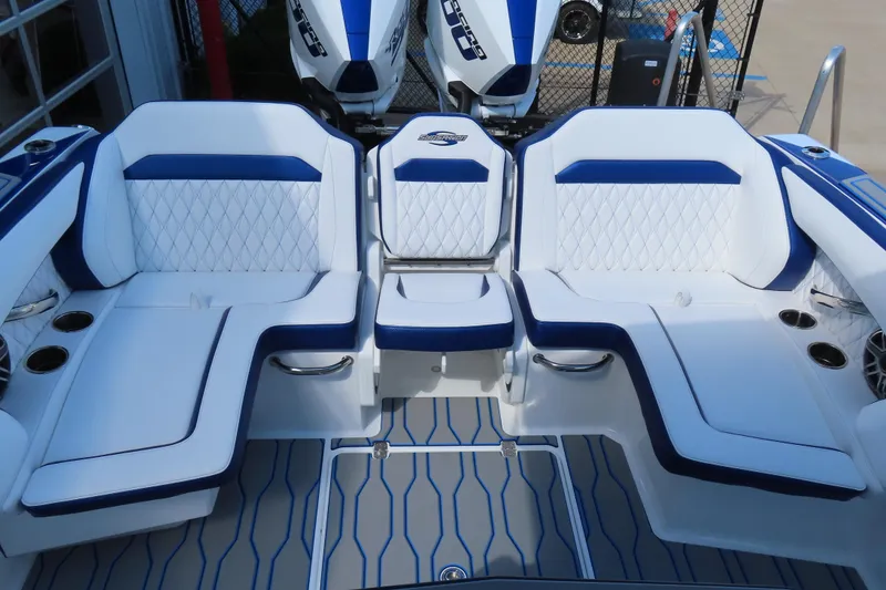 Slide: The Image of 2026 Sunsation 32CCX boat interior with white and blue seating, featuring modern design. - 24