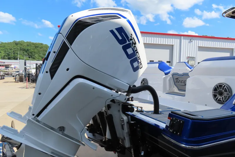 Slide: The Image of 2026 Sunsation 32CCX boat with powerful outboard motor, docked under clear blue sky. - 6