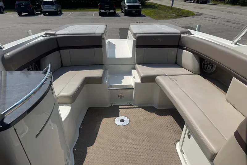 Slide: The Image of 2011 Sea Ray 270 SLX boat interior with beige seating and carpeted floor. - 10