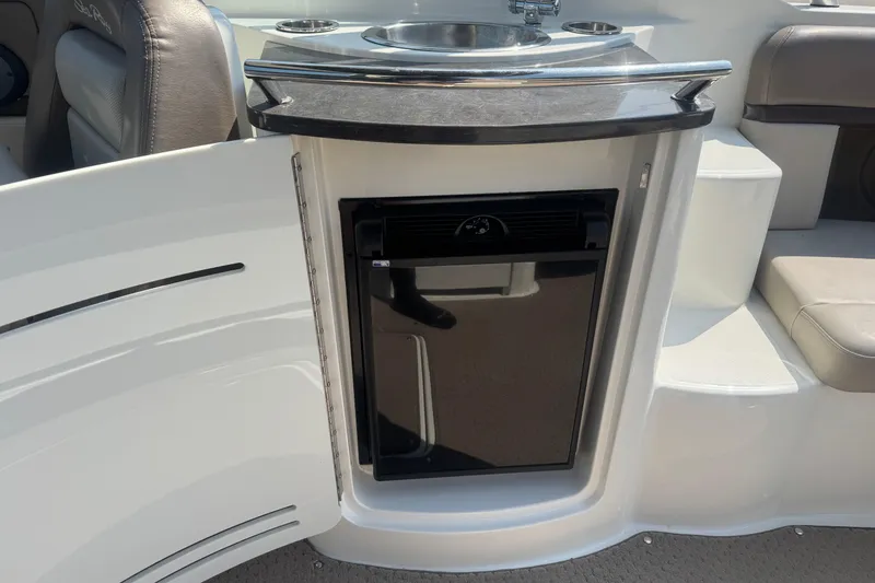 Slide: The Image of 2011 Sea Ray 270 SLX boat interior with mini fridge and sink. - 11