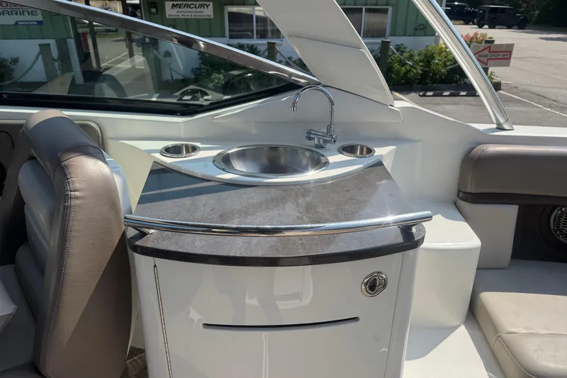 Slide: The Image of 2011 Sea Ray 270 SLX boat interior with sink and seating area. - 12