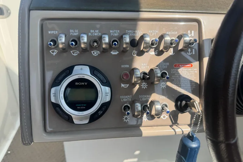 Slide: The Image of Control panel of a 2011 Sea Ray 270 SLX boat with various switches and a Sony marine stereo. - 14