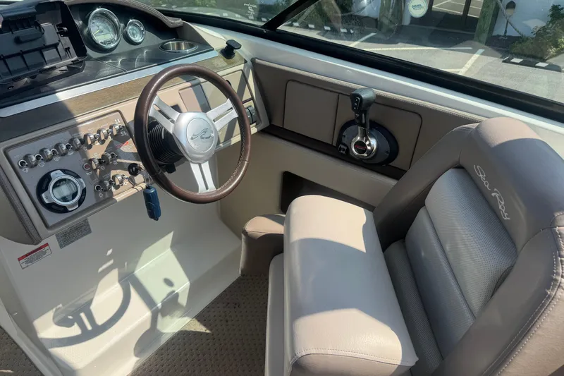 Slide: The Image of Interior view of 2011 Sea Ray 270 SLX boat cockpit with steering wheel and controls. - 15
