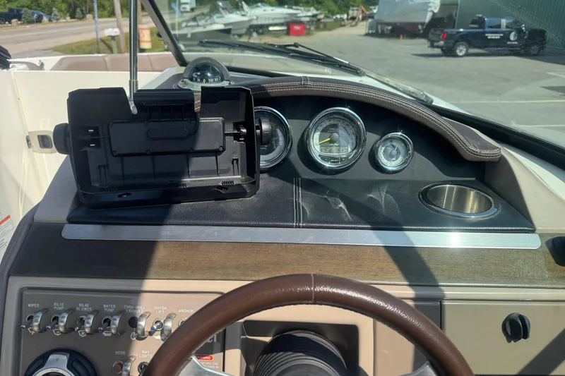 Slide: The Image of Dashboard of a 2011 Sea Ray 270 SLX boat with gauges and controls. - 16