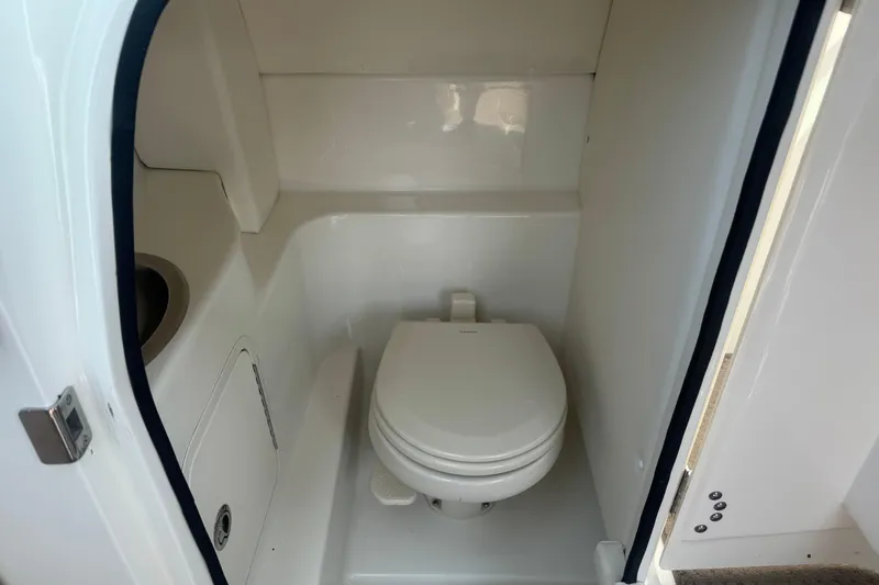 Slide: The Image of Interior of 2011 Sea Ray 270 SLX boat bathroom with toilet and sink. - 18