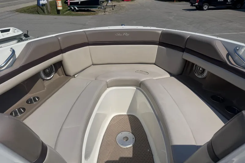Slide: The Image of 2011 Sea Ray 270 SLX boat interior with beige seating and cup holders. - 22