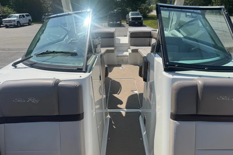 Slide: The Image of 2011 Sea Ray 270 SLX boat interior with seating and windshield in a parking lot. - 23
