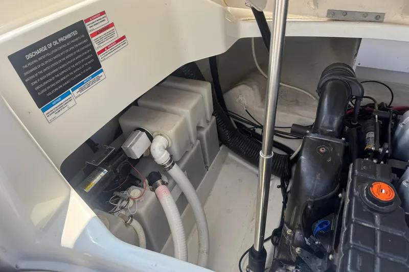 Slide: The Image of Engine compartment of a 2011 Sea Ray 270 SLX boat, showing mechanical components and warning labels. - 4