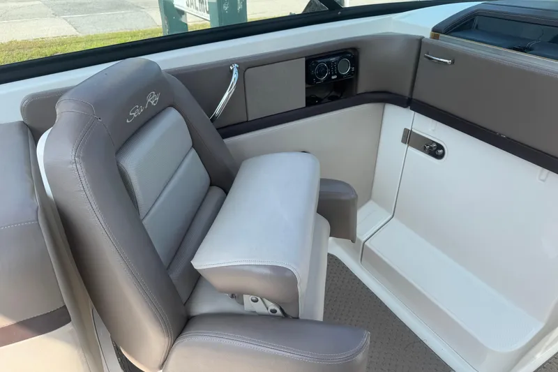 Slide: The Image of 2011 Sea Ray 270 SLX boat interior with gray seating and control panel. - 8