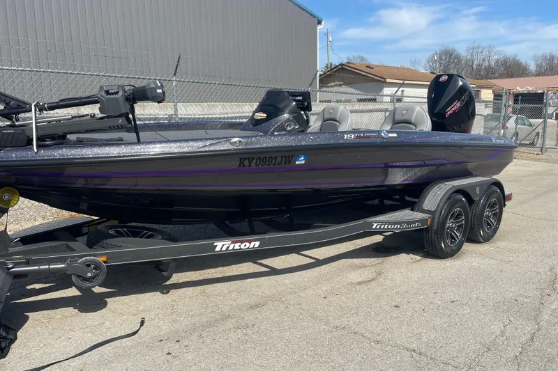 Slide: The Image of 2023 Triton 19TRX Patriot boat on trailer, parked outdoors. - 3