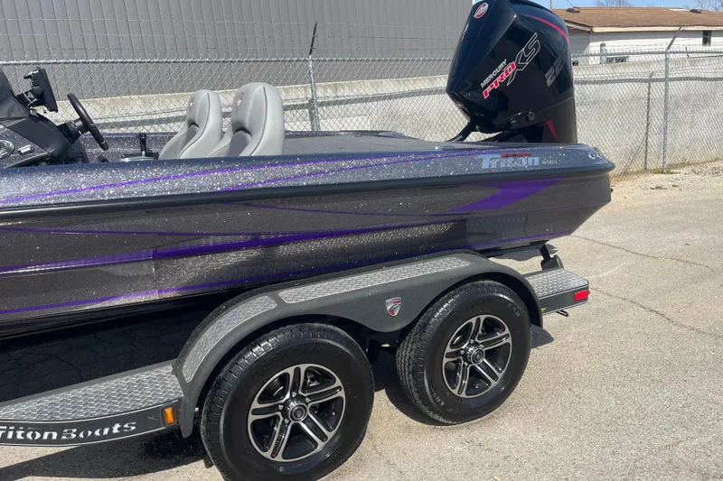Slide: The Image of 2023 Triton 19TRX Patriot boat with Mercury Pro XS engine on a trailer. - 4