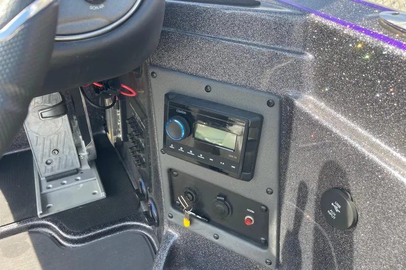 Slide: The Image of Dashboard of 2023 Triton 19TRX Patriot boat with audio system and controls. - 7