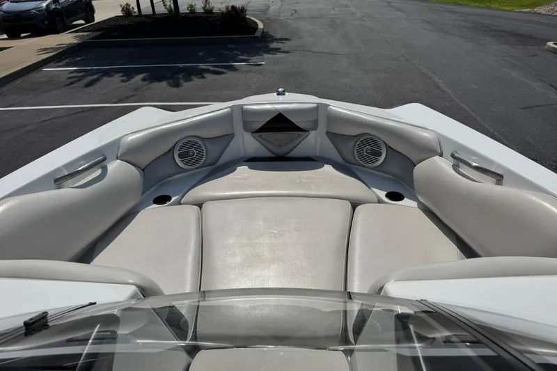 Slide: The Image of 2014 Axis A22 boat interior with cushioned seating and built-in speakers. - 8