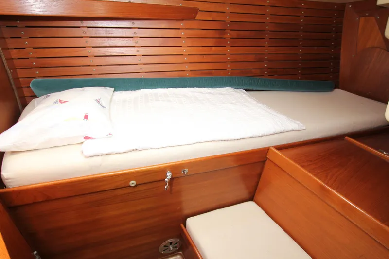 Slide: The Image of Cozy wooden cabin interior of 1982 Nautor Swan 371 sailboat with a comfortable bed. - 30