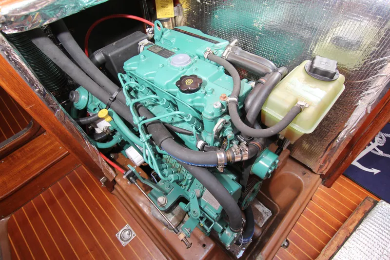 Slide: The Image of Engine compartment of a 1982 Nautor Swan 371 sailboat, featuring a well-maintained marine engine. - 32