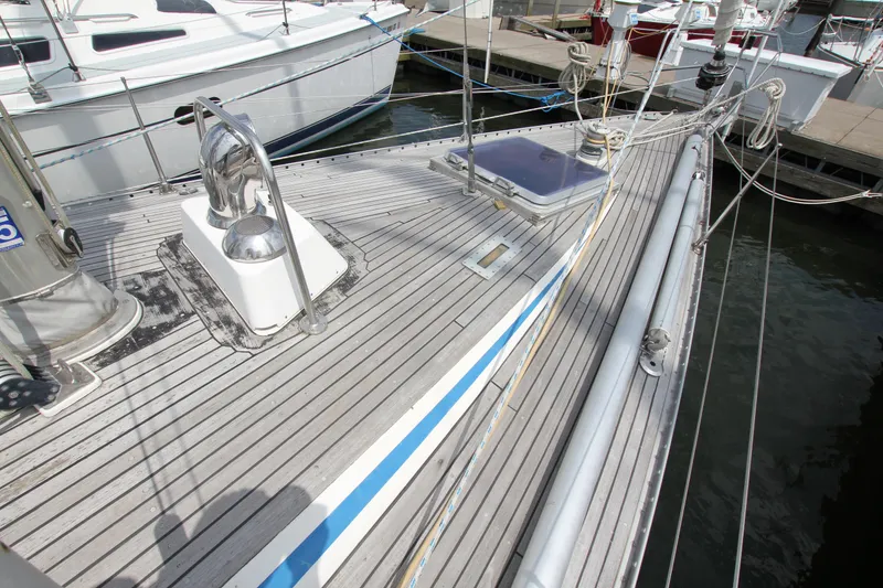 Slide: The Image of Deck of 1982 Nautor Swan 371 sailboat, featuring sleek design and mooring ropes. - 4