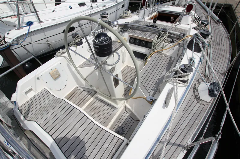 Slide: The Image of 1982 Nautor Swan 371 sailboat cockpit with wooden deck and steering wheel. - 9