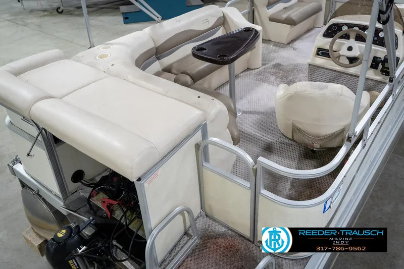 Slide: The Image of 2004 Bennington 185L pontoon boat interior with beige seating and steering console. - 13