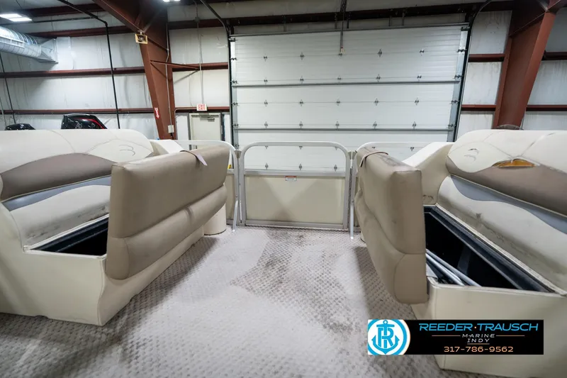 Slide: The Image of Interior view of a 2004 Bennington 185L pontoon boat in a garage setting. - 19