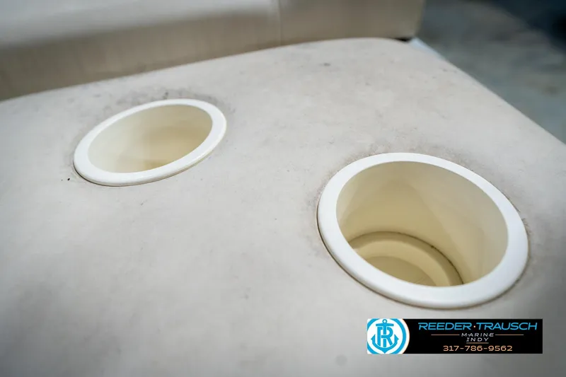 Slide: The Image of Two cup holders on a Bennington 185L boat, 2004 model, with Reeder-Trausch Marine logo. - 23