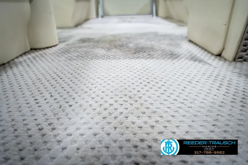 Slide: The Image of 2004 Bennington 185L boat interior with textured carpet flooring. - 24