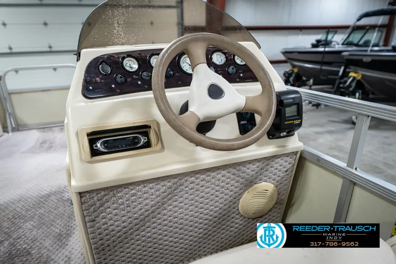 Slide: The Image of 2004 Bennington 185L boat dashboard with steering wheel and control panel in showroom. - 26