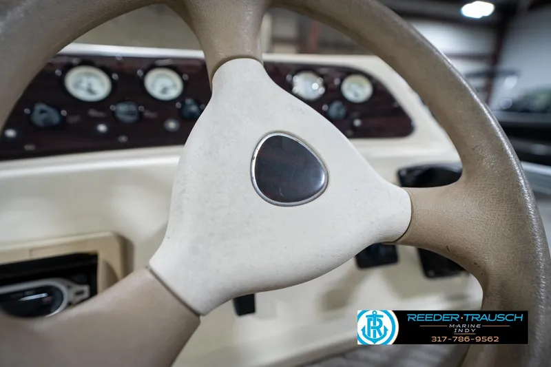 Slide: The Image of Steering wheel of a 2004 Bennington 185L boat with dashboard gauges visible. - 27
