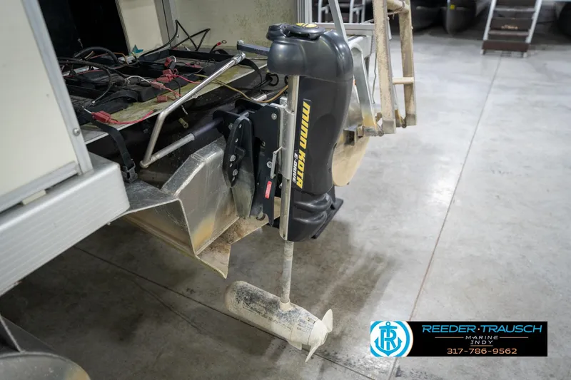 Slide: The Image of 2004 Bennington 185L boat with Minn Kota trolling motor in a garage setting. - 41