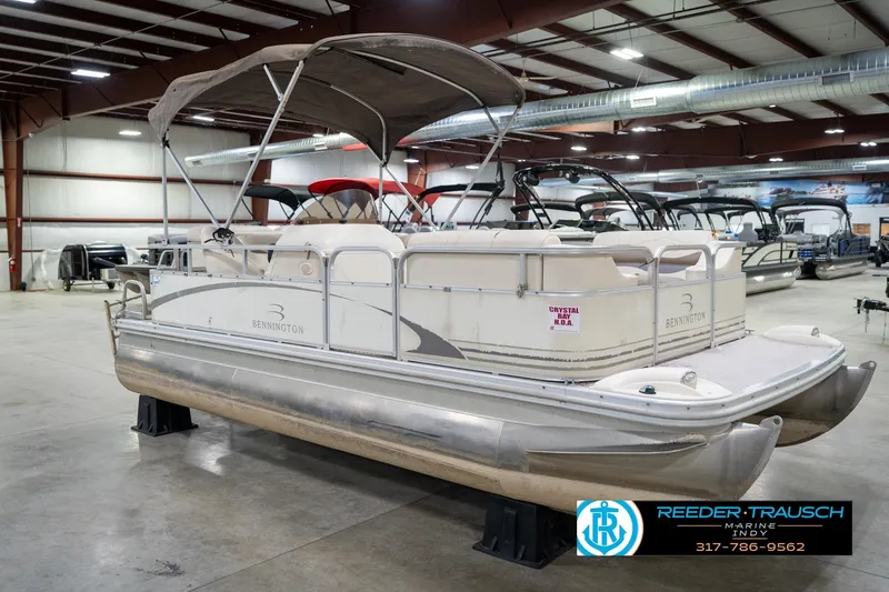 Slide: The Image of 2004 Bennington 185L pontoon boat displayed indoors at Reeder-Trausch Marine. - 5
