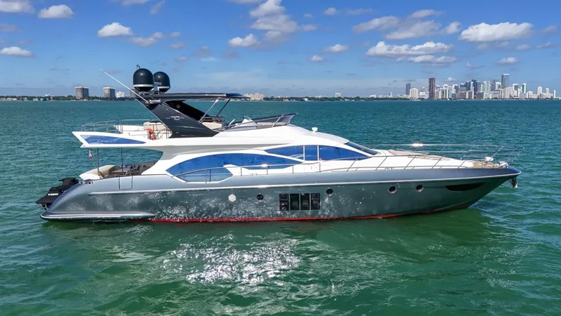 The Image of 2012 Azimut Flybridge yacht cruising on blue waters with city skyline in background. - 0