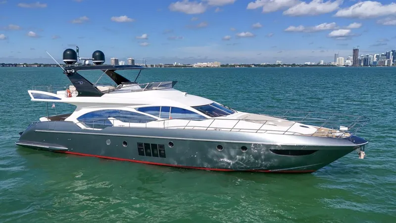 Slide: The Image of 2012 Azimut Flybridge yacht cruising on open water under a clear blue sky. - 10