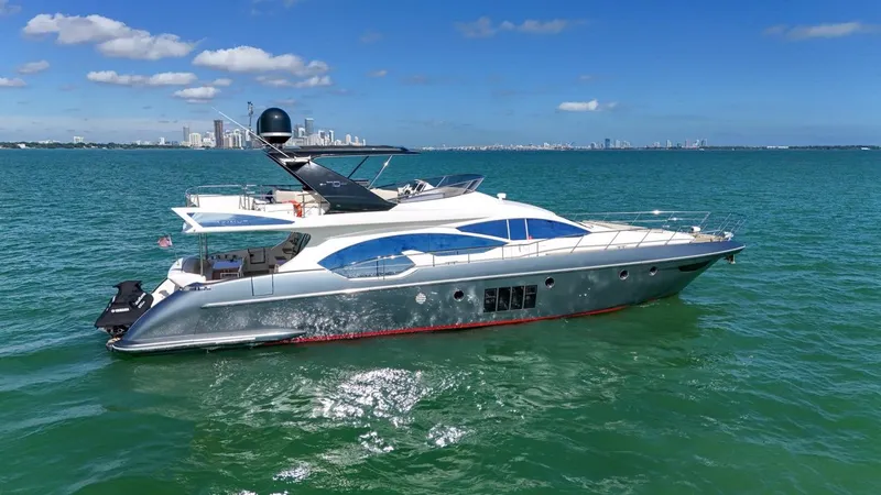 Slide: The Image of 2012 Azimut Flybridge yacht cruising on open water under clear skies. - 12