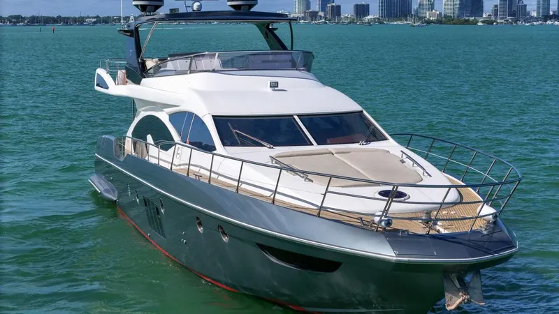Slide: The Image of Azimut Flybridge 2012 yacht on turquoise water with city skyline background. - 13