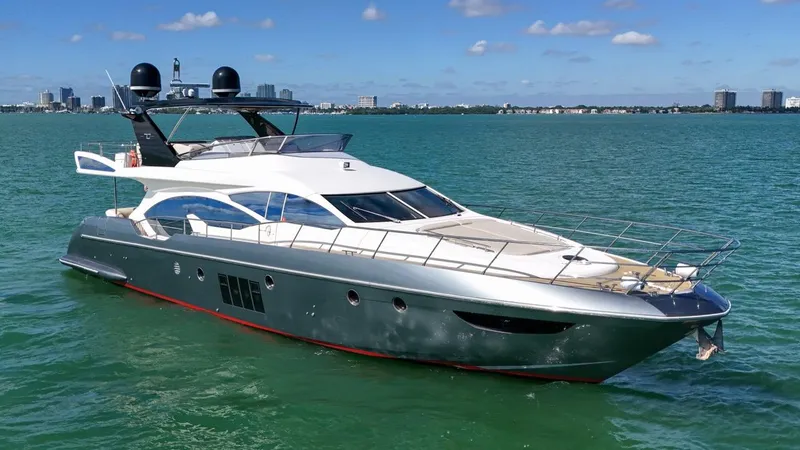Slide: The Image of Luxurious 2012 Azimut Flybridge yacht cruising on clear blue waters. - 14
