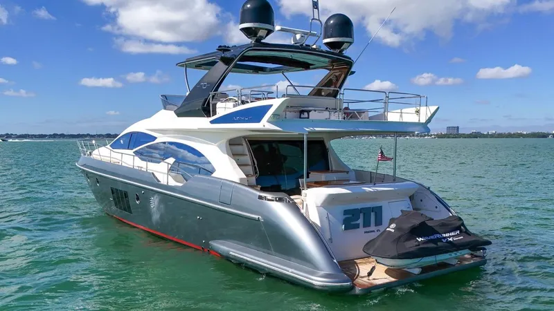 Slide: The Image of Luxury 2012 Azimut Flybridge yacht on serene water under blue sky. - 31