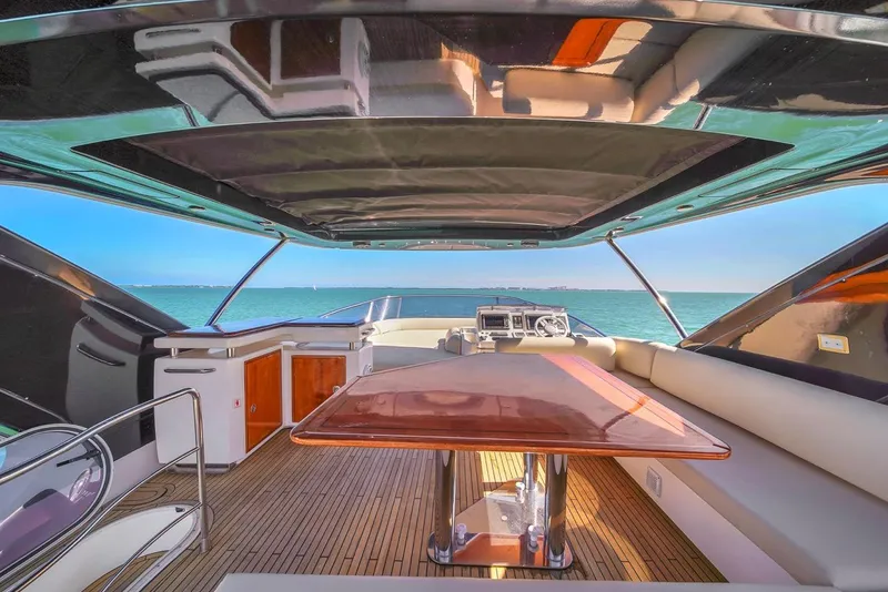 Slide: The Image of Luxurious 2012 Azimut Flybridge yacht interior with ocean view and elegant wooden table. - 37