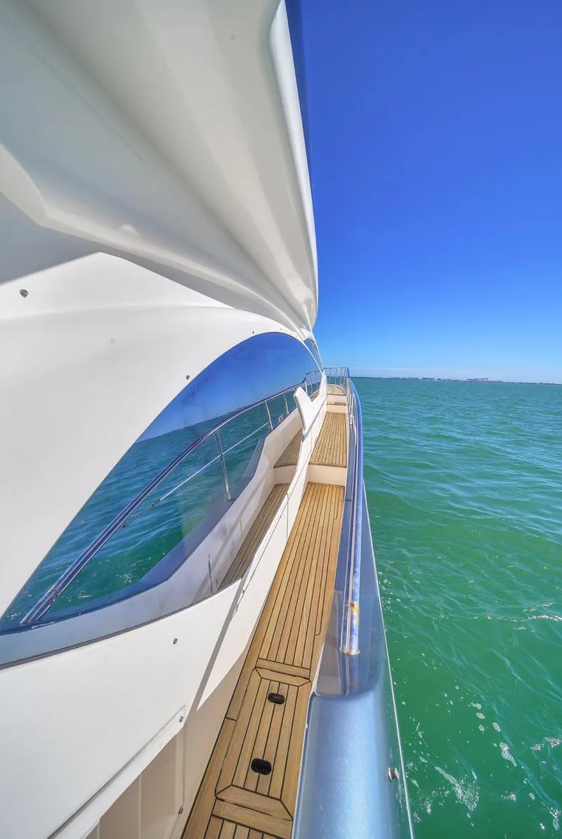 Slide: The Image of Azimut Flybridge 2012 yacht cruising on clear blue waters under a bright sky. - 49