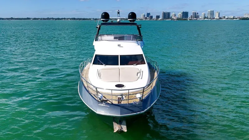 Slide: The Image of Azimut Flybridge 2012 yacht on turquoise water with city skyline in background. - 5