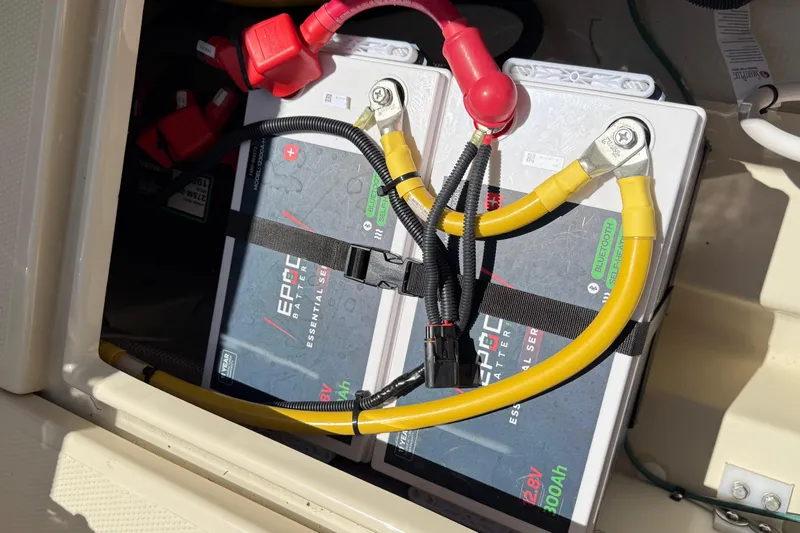 Slide: The Image of Battery compartment of 2025 Ranger Tugs R-23 with connected cables. - 19