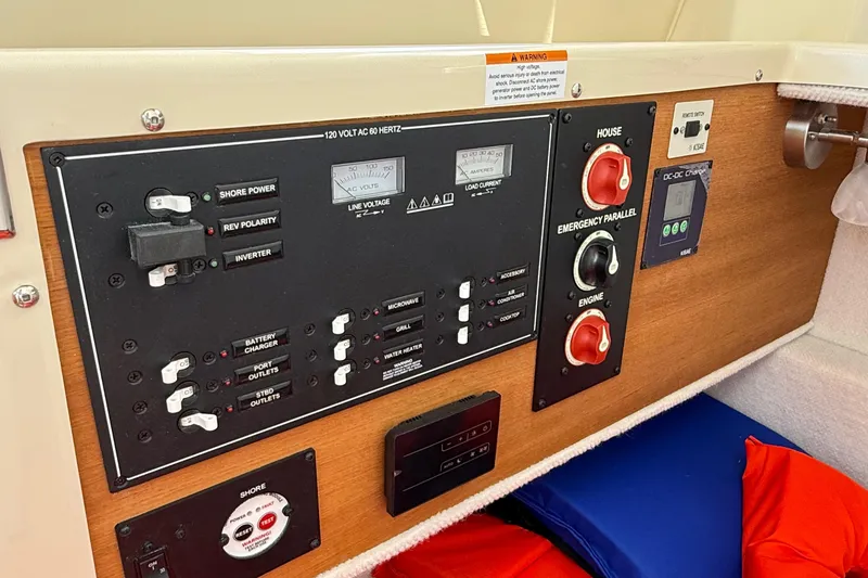 Slide: The Image of Control panel of 2025 Ranger Tugs R-23 boat, featuring electrical switches and gauges. - 21