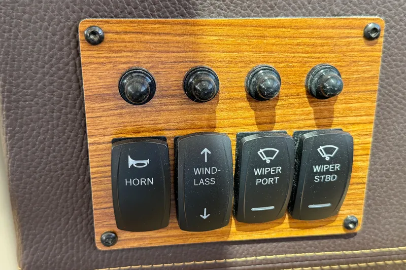 Slide: The Image of Control panel of 2025 Ranger Tugs R-23 boat with horn and wiper switches. - 22