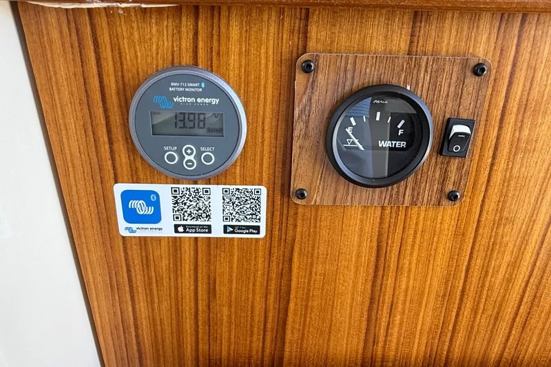 Slide: The Image of Control panel of 2025 Ranger Tugs R-23 with battery and water gauges. - 28