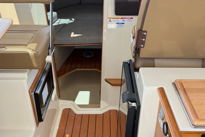 Slide: The Image of Interior of 2025 Ranger Tugs R-23 boat with seating and wood flooring. - 39