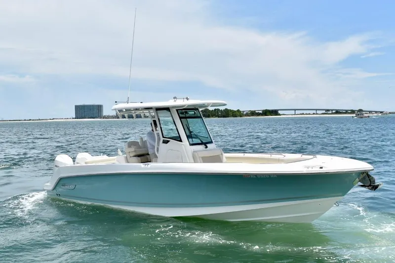 Slide: The Image of 2023 Boston Whaler 280 Outrage boat cruising on open water under a clear sky. - 4